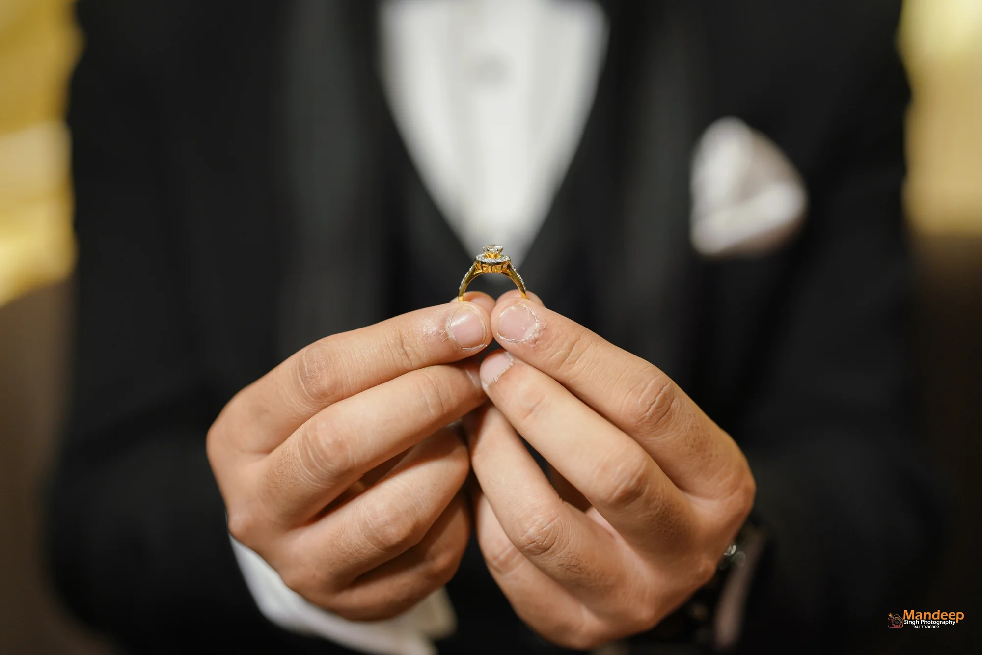 The engagement ring held between Vyom’s hands